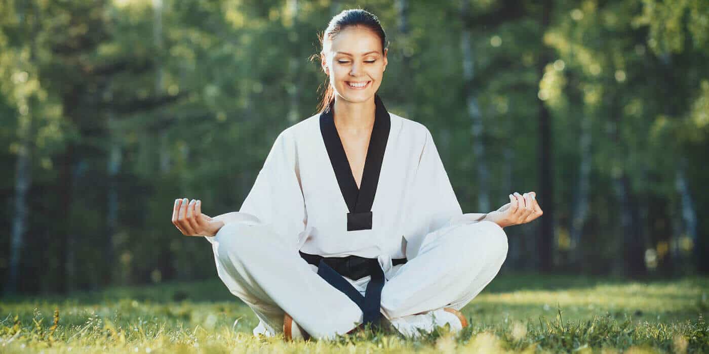 Martial Arts Lessons for Adults in Orlando FL - Happy Woman Meditated Sitting Background