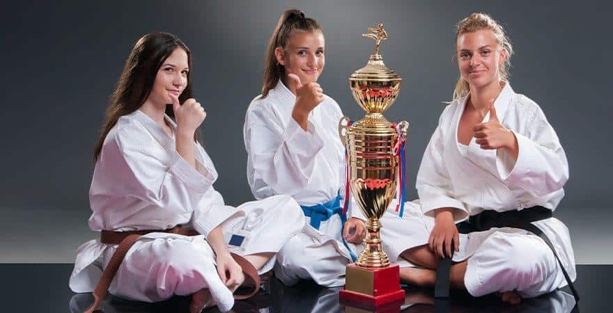 Martial Arts Lessons for Kids in Orlando FL - Thumbs Up and Trophies with Sitting Girls